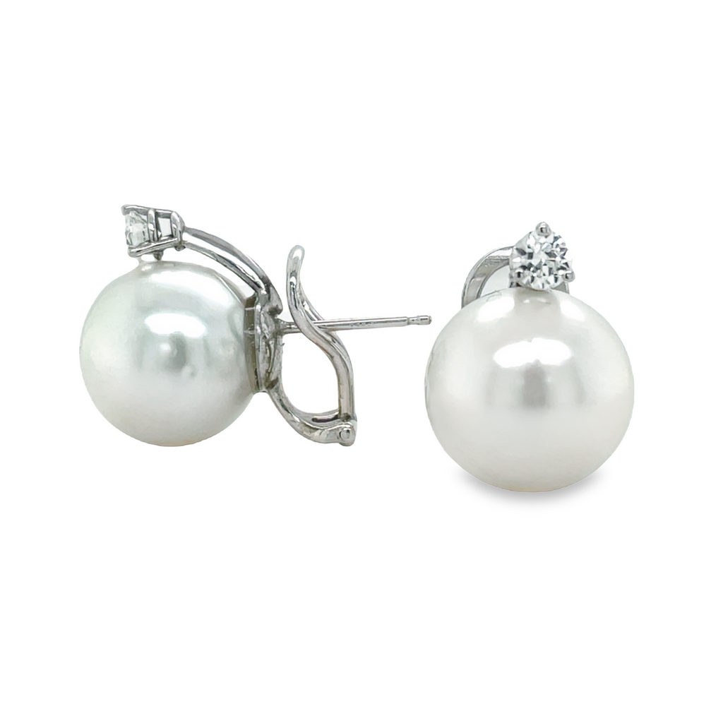 Adorn yourself with exquisite beauty! These South Seas Pearl 14mm Earrings boast an excellent luster and shimmering 0.50ct round diamonds set in 14k white gold. The backs are a secure clip omega system.
