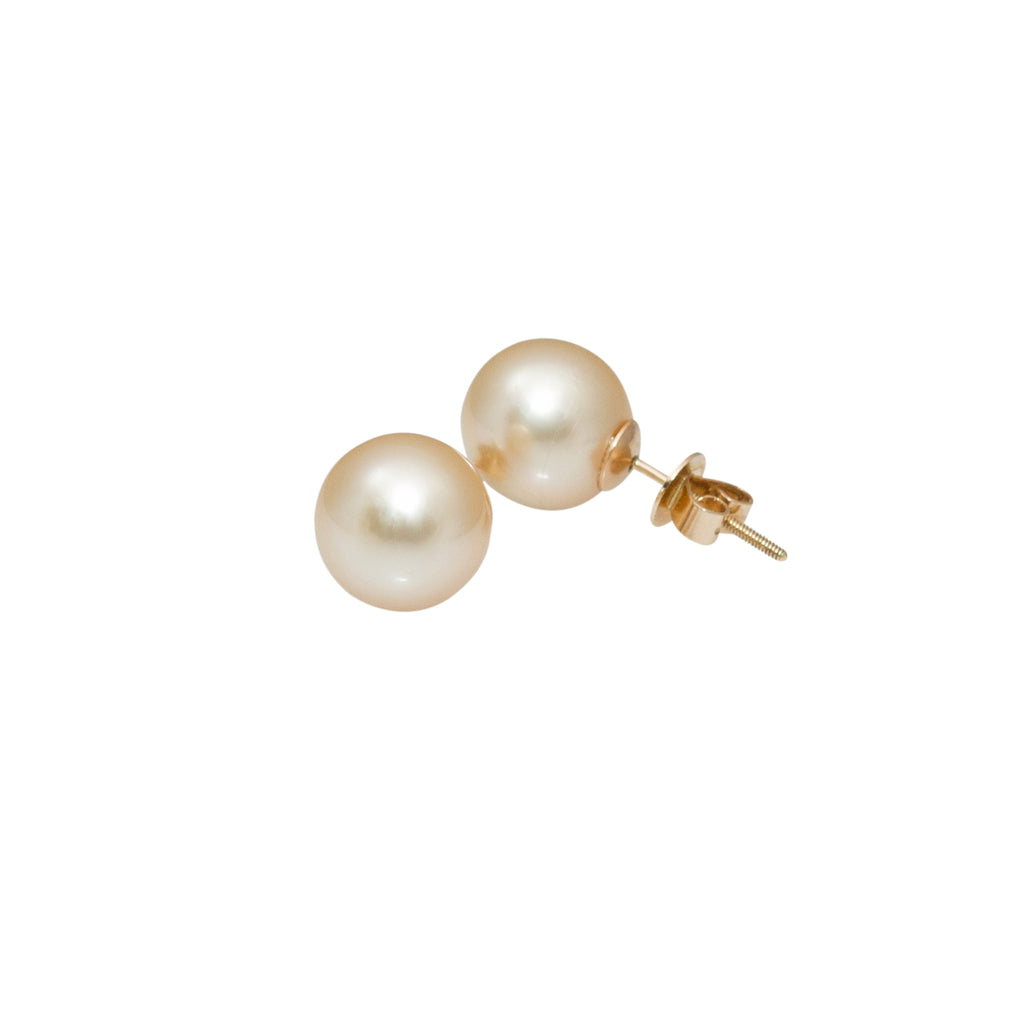 Enchanting cultured, golden South Sea pearls, 11mm in size, captivate the eyes with their gleaming luster. Skillfully cradled in 14k yellow gold cups, they are comfortably secured with a precision screw back system.