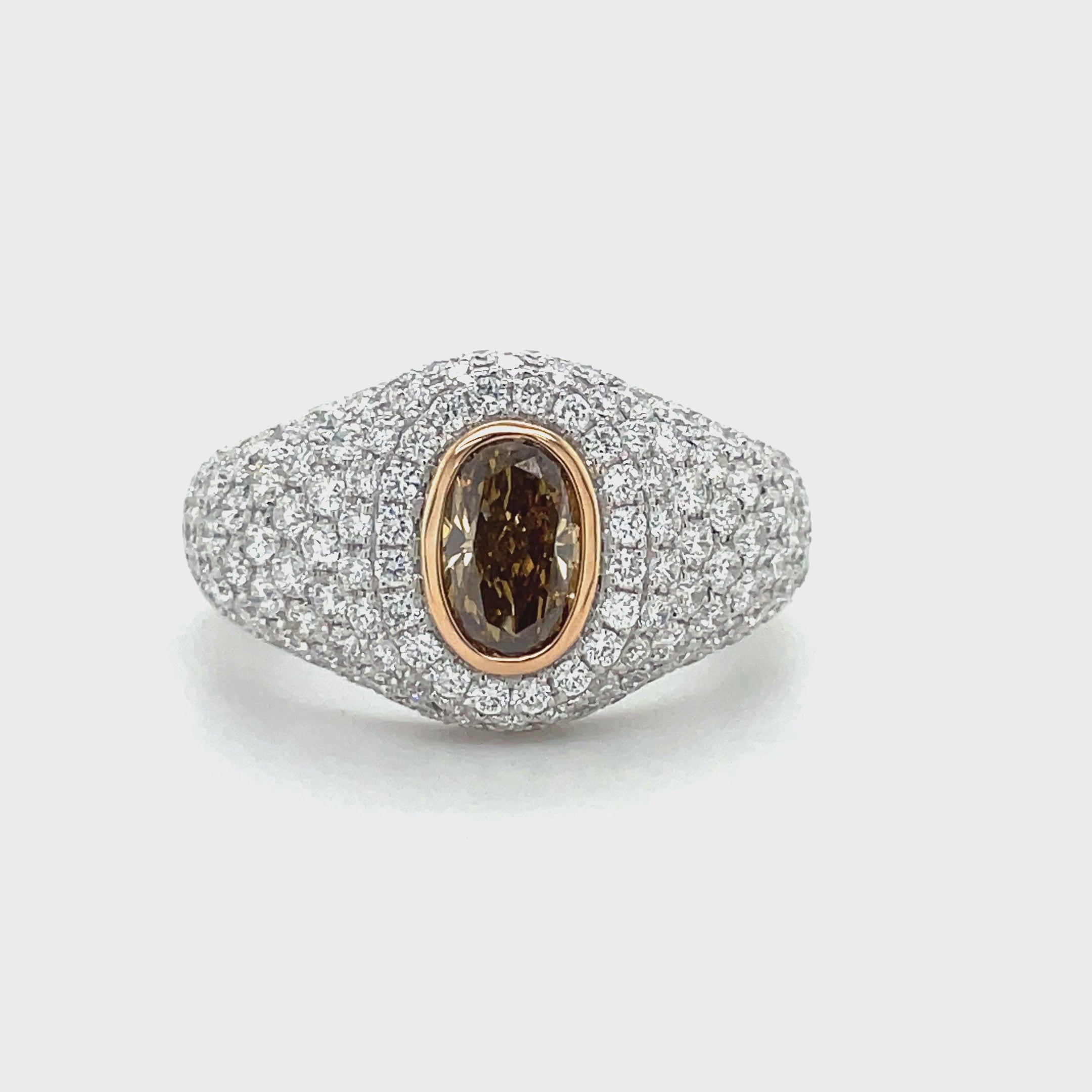 A champagne diamond is a type of colored diamond that’s naturally brown, with a noticeable yellow tint.   Set in 18k white gold.  Round white diamonds 1.44 cts bezel set in 18k yellow gold.  One oval champagne diamond 0.55 cts