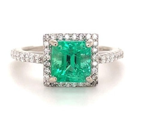 Beautiful engagement ring   Center stone:  2.40 cts Colombian Emerald   Medium green  Four prong set  Set in 14k yellow gold with round diamonds 0.70 cts   Color F/G