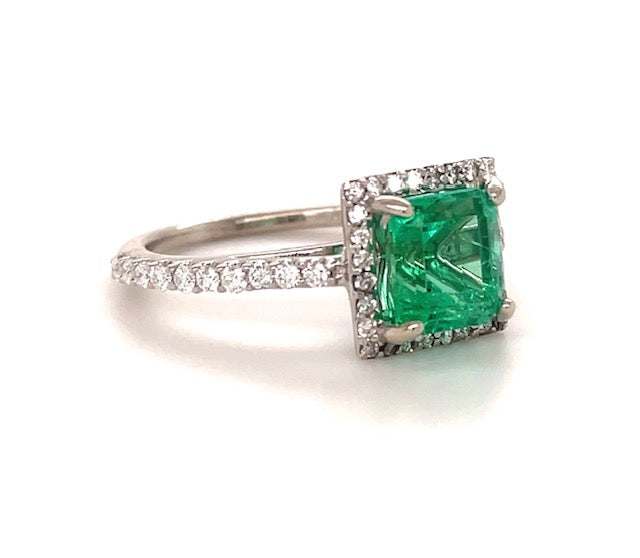 Center stone:  1.40 cts Colombian Emerald   Medium green  Four prong set  Set in platinum with round diamonds 0.52 cts   Color F/G