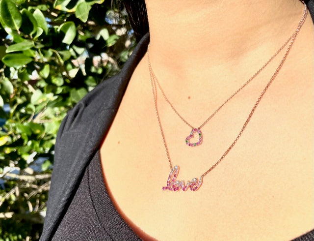 This exquisite Love necklace is crafted from 14k rose gold and glitters with 0.18cts of sparkling round diamonds and 0.74cts of beautiful multicolor sapphires! The piece is designed with a secure lobster clasp and an 18" chain, with a sizing loop at 16". 