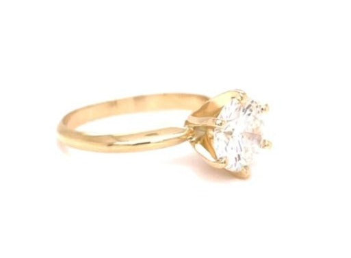 A magnificent 1.01 ct round cut diamond with G/H color and SI1 clarity is held securely in a six prong 14k yellow gold mounting, creating a timeless solitaire engagement ring!