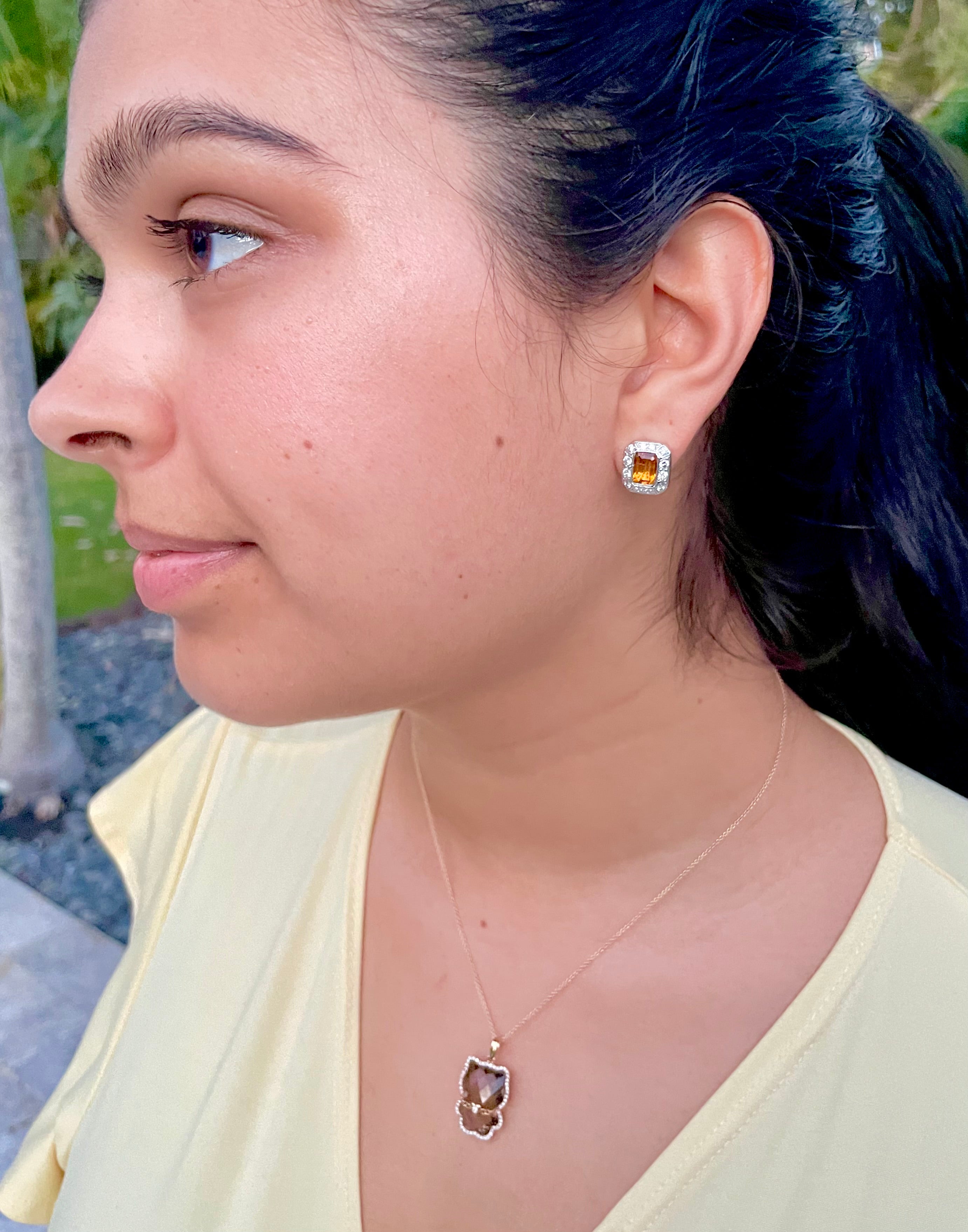 The Bezel Set Citrine Diamond Earrings offer sparkling style with 1.80 carats of round diamonds, emerald-cut citrine gems and 14k white gold. Finished with secure omega clips and a gallery finish of 14.00 mm, these earrings are a timeless addition to any jewelry collection.