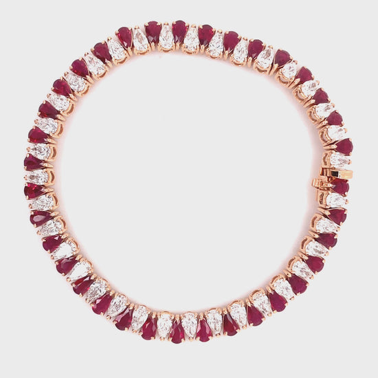 Stunning one of a kind bracelet  Smooth movement  Hidden clasp  18k rose gold  Pear shape rubies 6.41 cts   Pear shape diamond 6.27 cts   7" long 