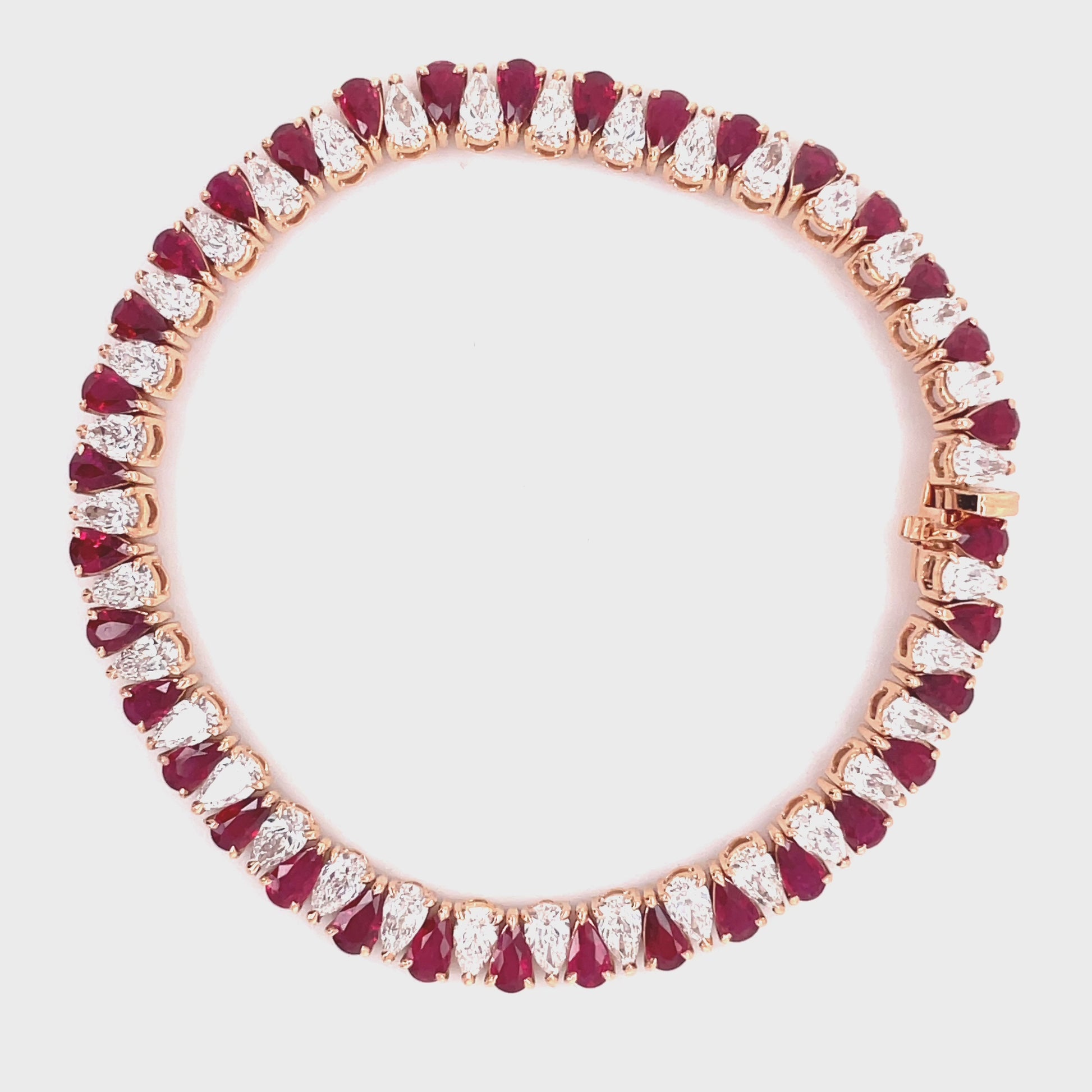 Stunning one of a kind bracelet  Smooth movement  Hidden clasp  18k rose gold  Pear shape rubies 6.41 cts   Pear shape diamond 6.27 cts   7" long 