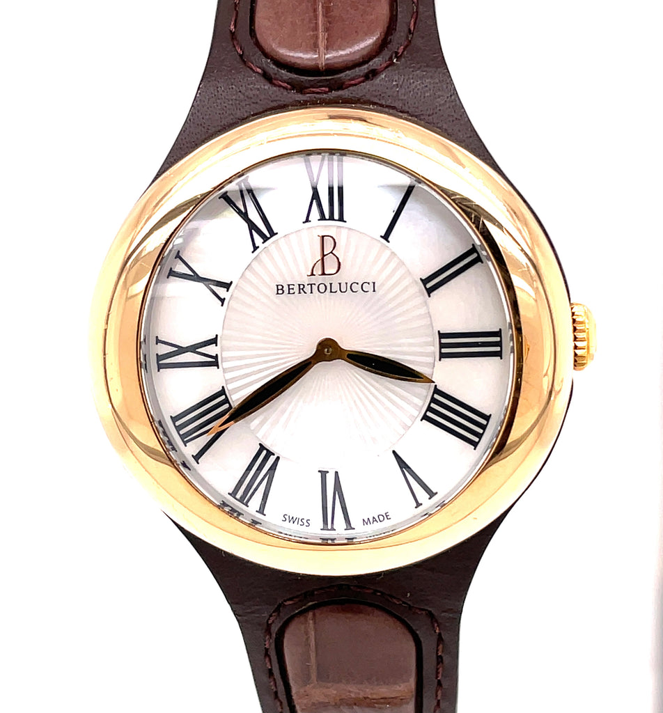 Bertolucci's timepiece boasts a stainless steel case paired with an 18k rose gold bezel and a Mother-of-Pearl dial with Roman numerals. A dark brown alligator band with a double folding clasp completes the look. 303.51.47.3B1.366