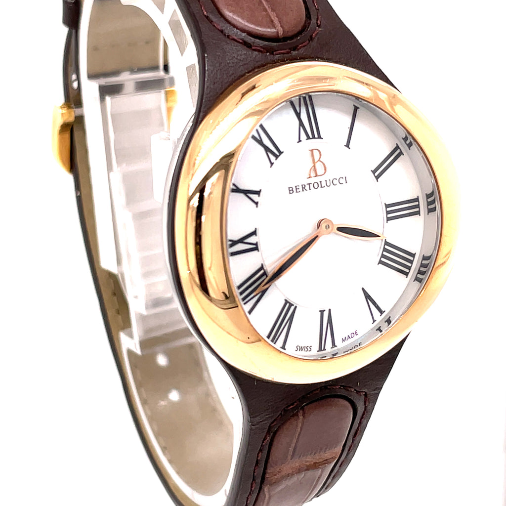 Bertolucci's timepiece boasts a stainless steel case paired with an 18k rose gold bezel and a Mother-of-Pearl dial with Roman numerals. A dark brown alligator band with a double folding clasp completes the look. 303.51.47.3B1.366