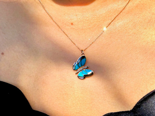 Tilted 18kt rose gold butterfly pendant  0.05 cts round diamonds   Seamless mother of pearl & turquoise set in the wings  30.00 mm long (including secure bail)  All mother of pearl at the back (it can be used both sides)  High quality diamonds   16" rose gold chain with secure lobster catch 