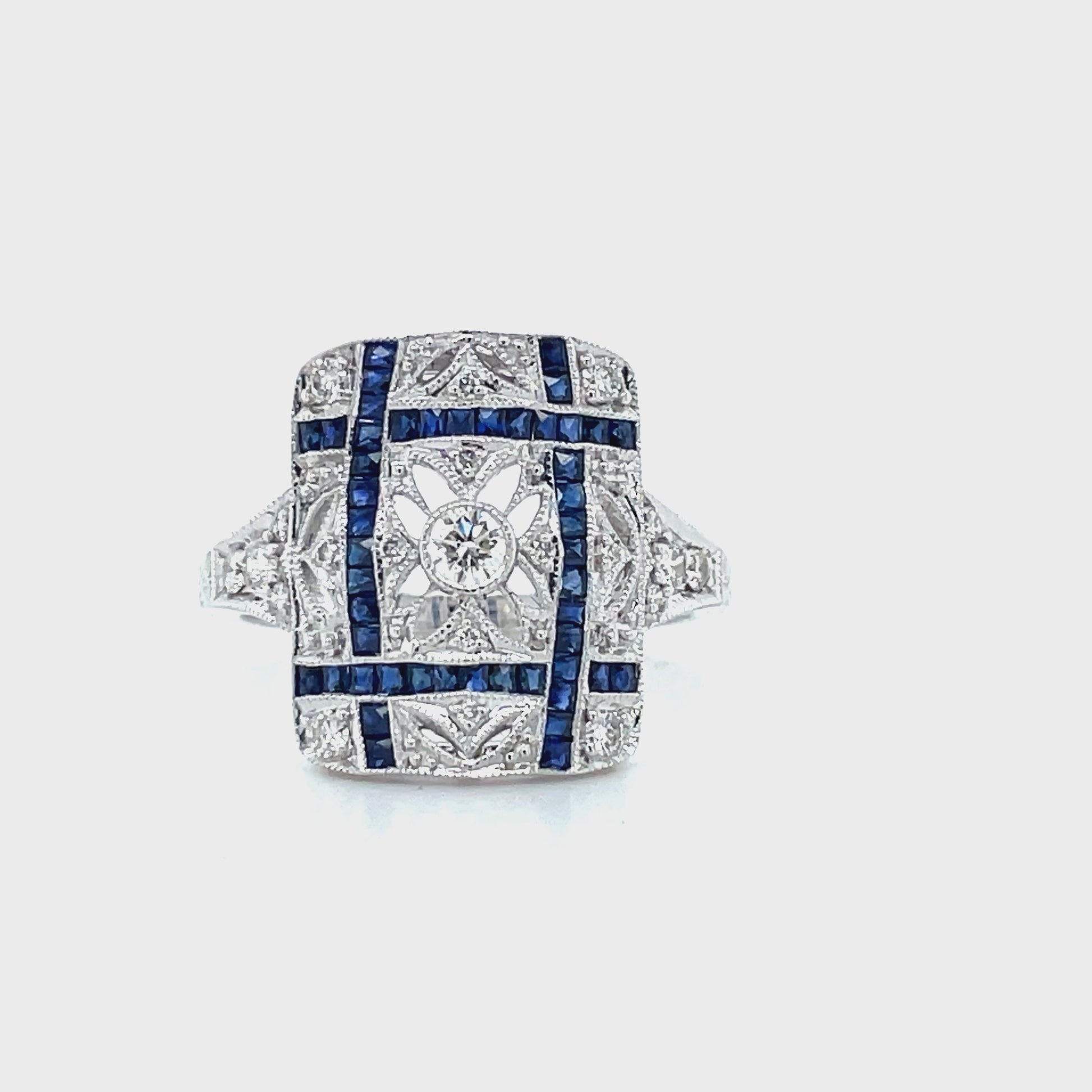 Handmade design  Round sapphire 0.60 cts  Round diamonds 0.29 cts  Set in a 14k white gold   Size 6.5 (sizable)  Art deco geometrical style.  Carved into filigree pattern.  16.00 x 13.00 mm 