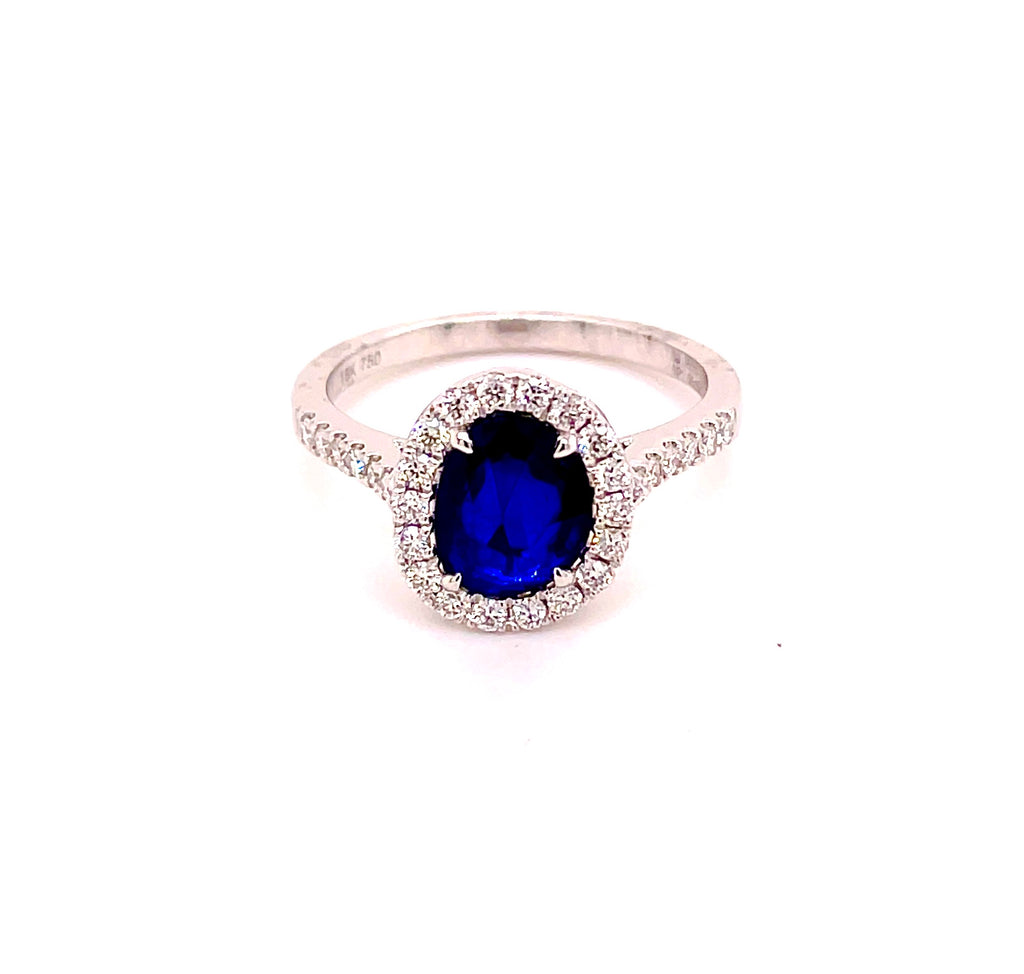 14k yellow gold  Surrounded by white round diamonds 0.36 cts   Size 7  Oval faceted sapphire 1.05 cts  11.30 mm.