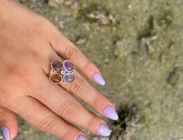 Set in 14k rose gold  4 cabochon stones; amethyst, blue topaz, citrine & moonstone   Five small round diamonds  Size 6 (sizeable)