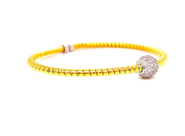 Innovated tubogas technique that allows flexibility   Classic and contemporary design   18k yellow & white gold   Slip on bracelet  Round diamonds  0.53 cts.  8.00 mm wide.