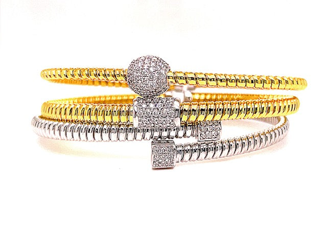 Italian made  Innovated tubogas technique that allows flexibility   Classic and contemporary design   18k yellow & white gold   Slip on bracelet  Round diamonds  0.10 cts.  4.60 mm wide.