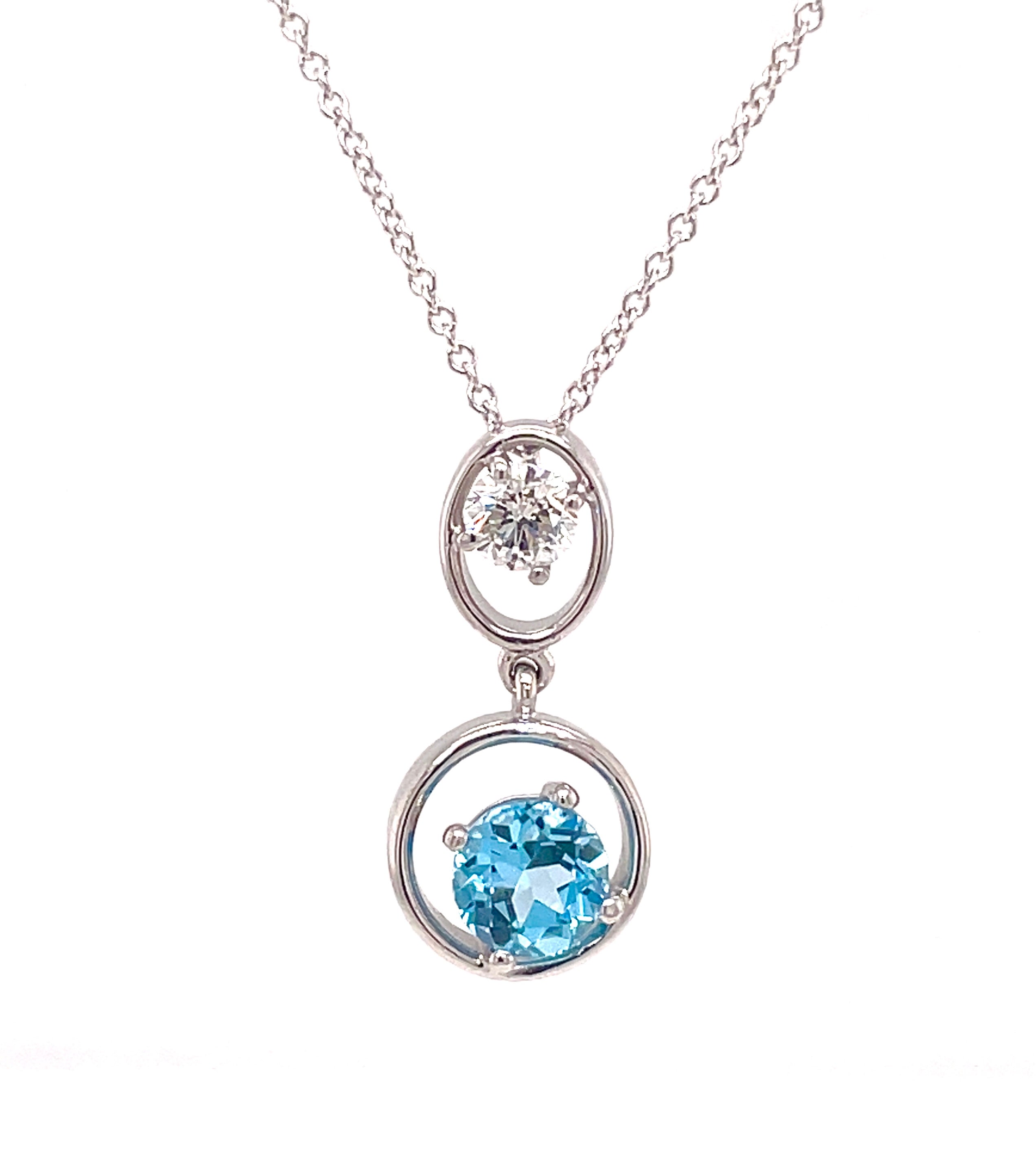 This necklace features a circle composed of one oval blue topaz with a total weight of 1.21 ct, set with a single round diamond at 0.33 cts, all crafted in 14k white gold. The necklace is a 14k white gold chain link with a secure lobster clasp with a length of 18".