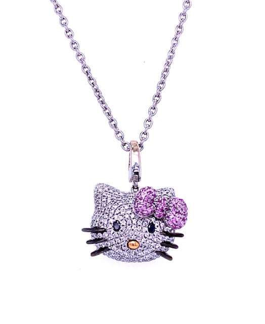One of a kind Kitty. This is the ultimate Hello Kitty Pendant Collection for all the fans of this memorable character.   White round diamonds in a pave setting for the cute face 1.20 cts  Round pink sapphires for her bow 0.25 cts  18k yellow gold drop for her nose  Black onyx for eyes & whiskers   18" long solid chain  Secure lobster clasp  Gallery finish at the back of the pendant  Secure bail to place in any other chain