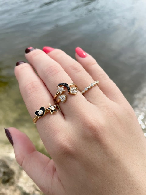 Indulge in a timeless piece that sparkles with elegance! Crafted with 18k yellow gold, this ring is adorned with a small, round diamond and a captivating black enamel. Size 6 (resizable).