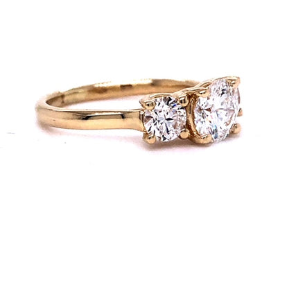 An absolutely stunning custom made Three Stone Engagement Ring in yellow gold awaits you! Featuring a magnificent 0.93 carat, Color D, Clarity VS2 GIA Certified center stone and two round diamonds of 0.70 carats Color G/H and Clarity VS2, all set in a beautiful 14k yellow gold band. A perfect expression of the eternal bond of love!