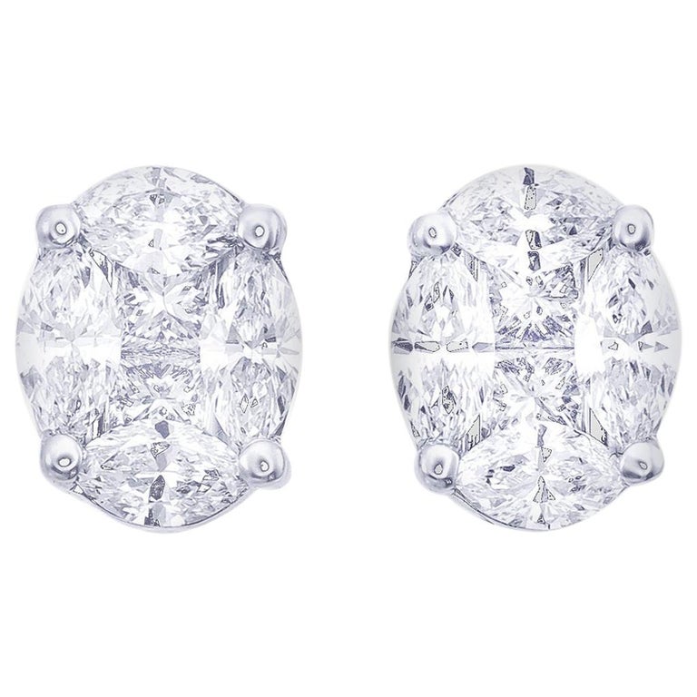 Extremely well made  High quality diamonds   Set in 18k white gold  Mixed fancy cut diamonds 1.20 cts (marquise & square)  Gives the look of 1.50 studs  Color F/G  Clarity VS1  Secure friction backs.  7.00 mm wide