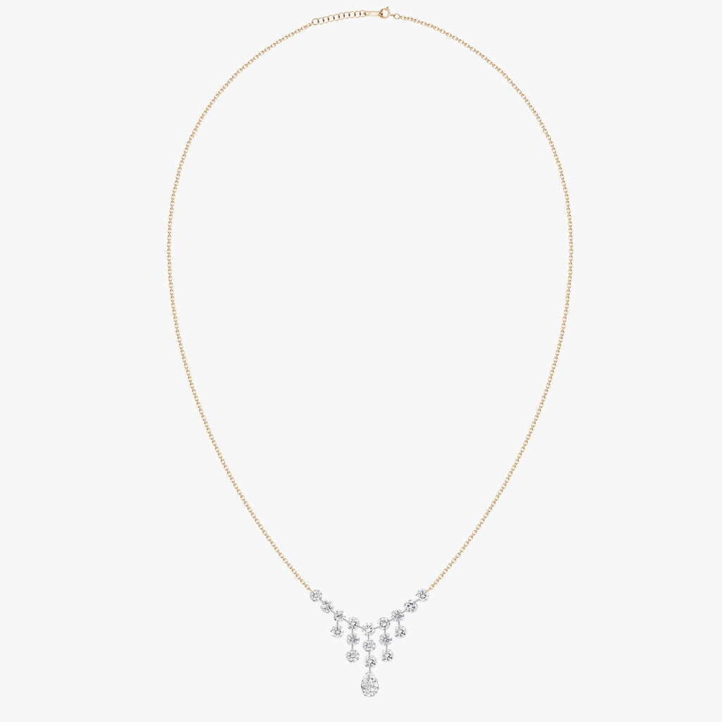Stunning dangling diamond necklace that is constantly moving and shining.   Lasered drilled round diamonds 0.97 cts,  Secure clasp.  18" yellow gold chain with adjustable chain   It can easy be layered with your favorite necklaces  High quality diamonds  18k white gold