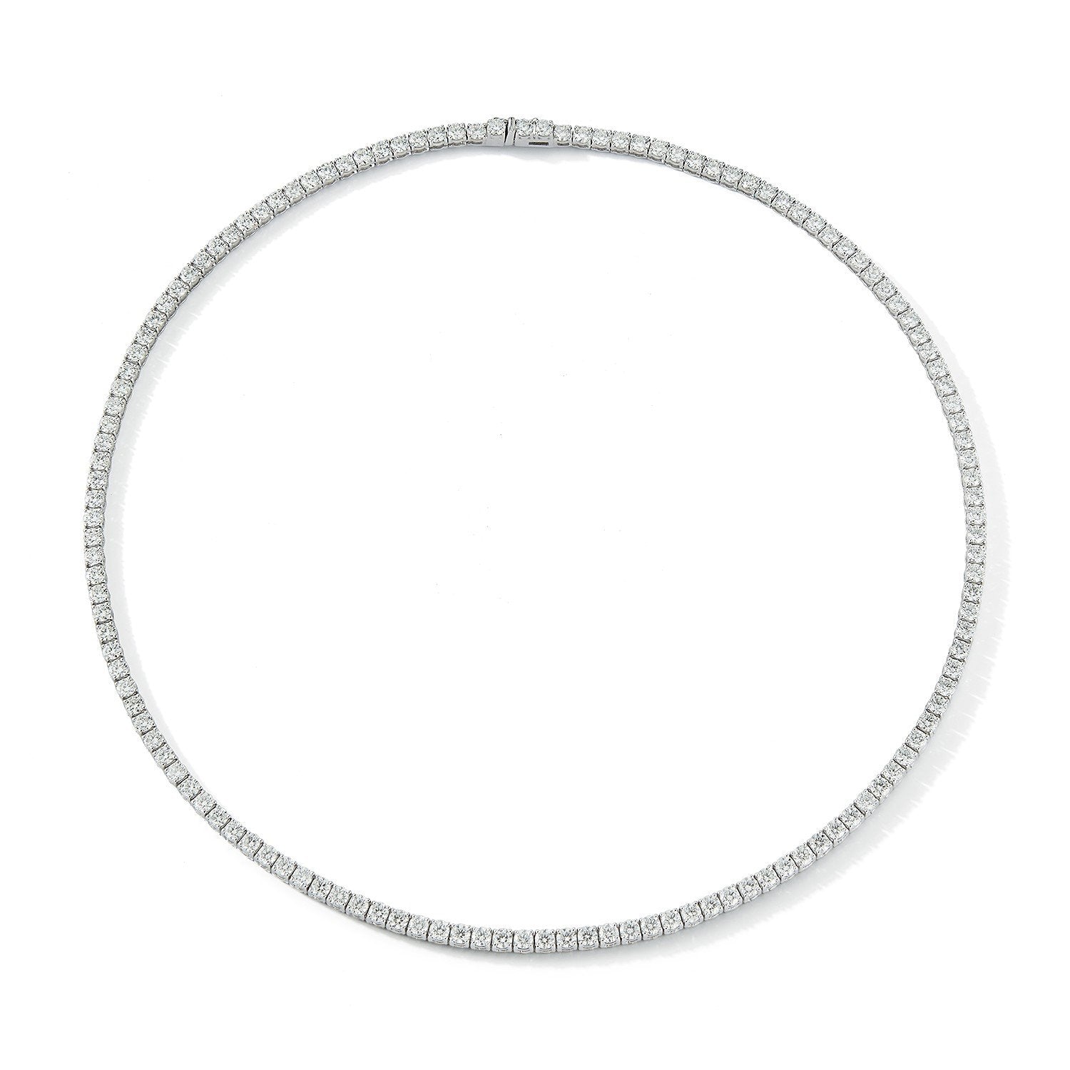 ndulge in luxury with our Diamond Tennis Necklace. Featuring a dazzling 7.00 cts of stunning round diamonds in a captivating 14k white gold block setting. The secure lobster catch adds a touch of sophistication to the 17" long necklace. Elevate any outfit with the elevated elegance of this necklace.