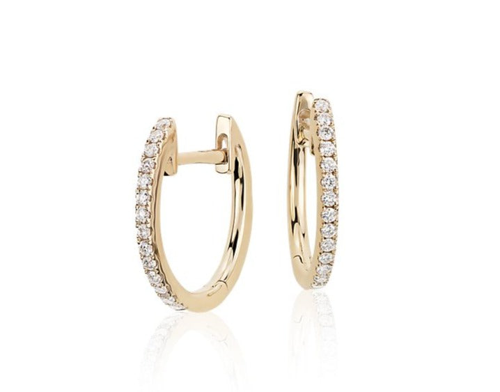 These Small Diamond Huggie Earrings feature 0.14 cts of round diamonds set in 18k yellow gold. Measuring 13.00mm long, the oval shape and secure hinged system make them easy to wear. A beautiful addition to any jewelry collection.