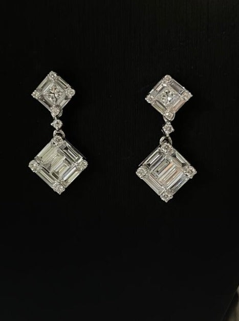 Make a statement with our Diamond Tilted Square Double Drop Illusion Setting Earrings. These 18k white gold earrings feature a tilted design that creates the illusion of a large emerald cut diamond. With a total of 1.25 cts of round and baguette cut diamonds, these earrings are sure to catch everyone's eye. The large earrings back provides comfort and security. Perfect for any special occasion.