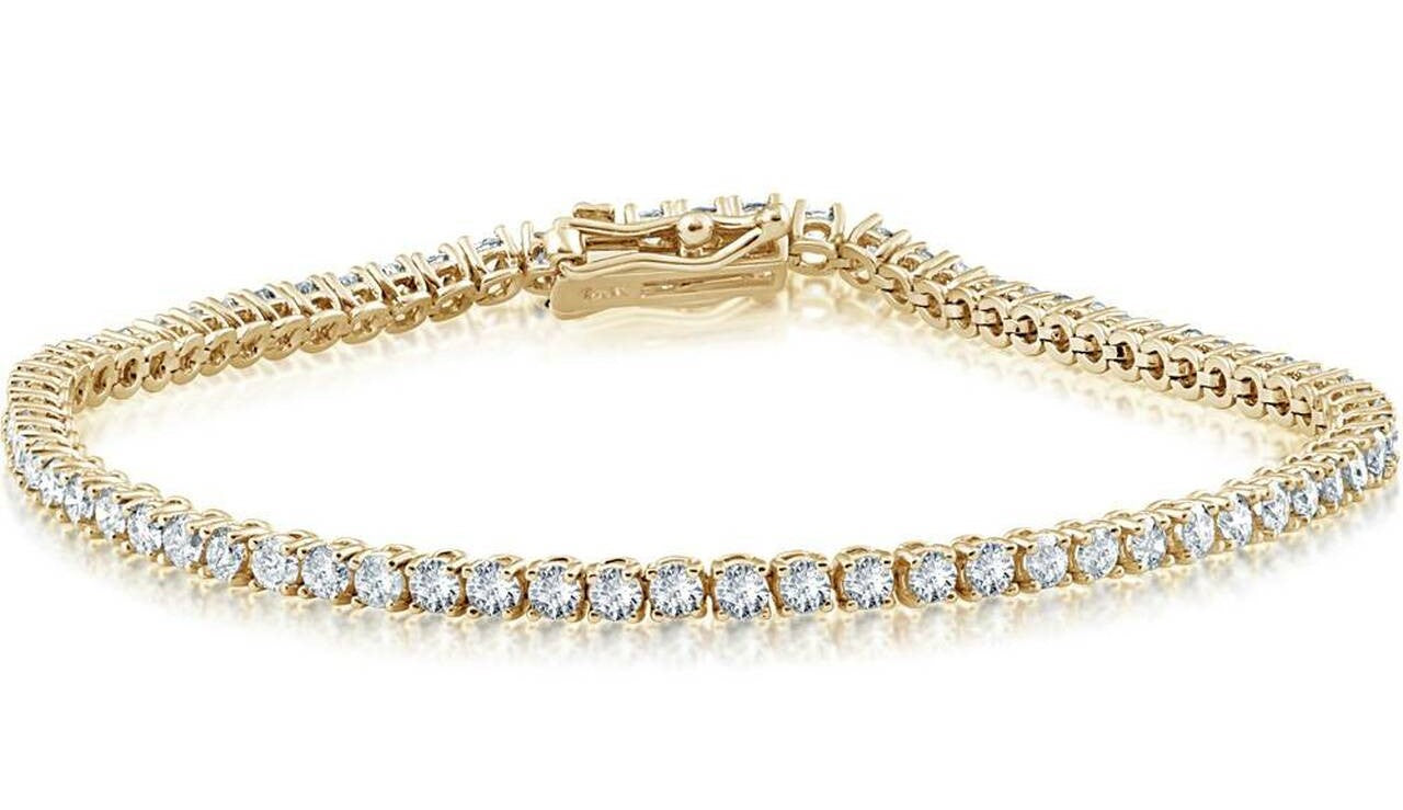 Indulge in luxury with our Yellow Diamond Tennis Bracelet. Crafted with 14 yellow gold and adorned with 2.30 cts of round diamonds, this bracelet exudes elegance and sophistication. The secure clasp and double figure 8 design ensure a perfect fit for a flawless accessory. Feel exclusive with this 7" long bracelet. Color G/H, Clarity VS2